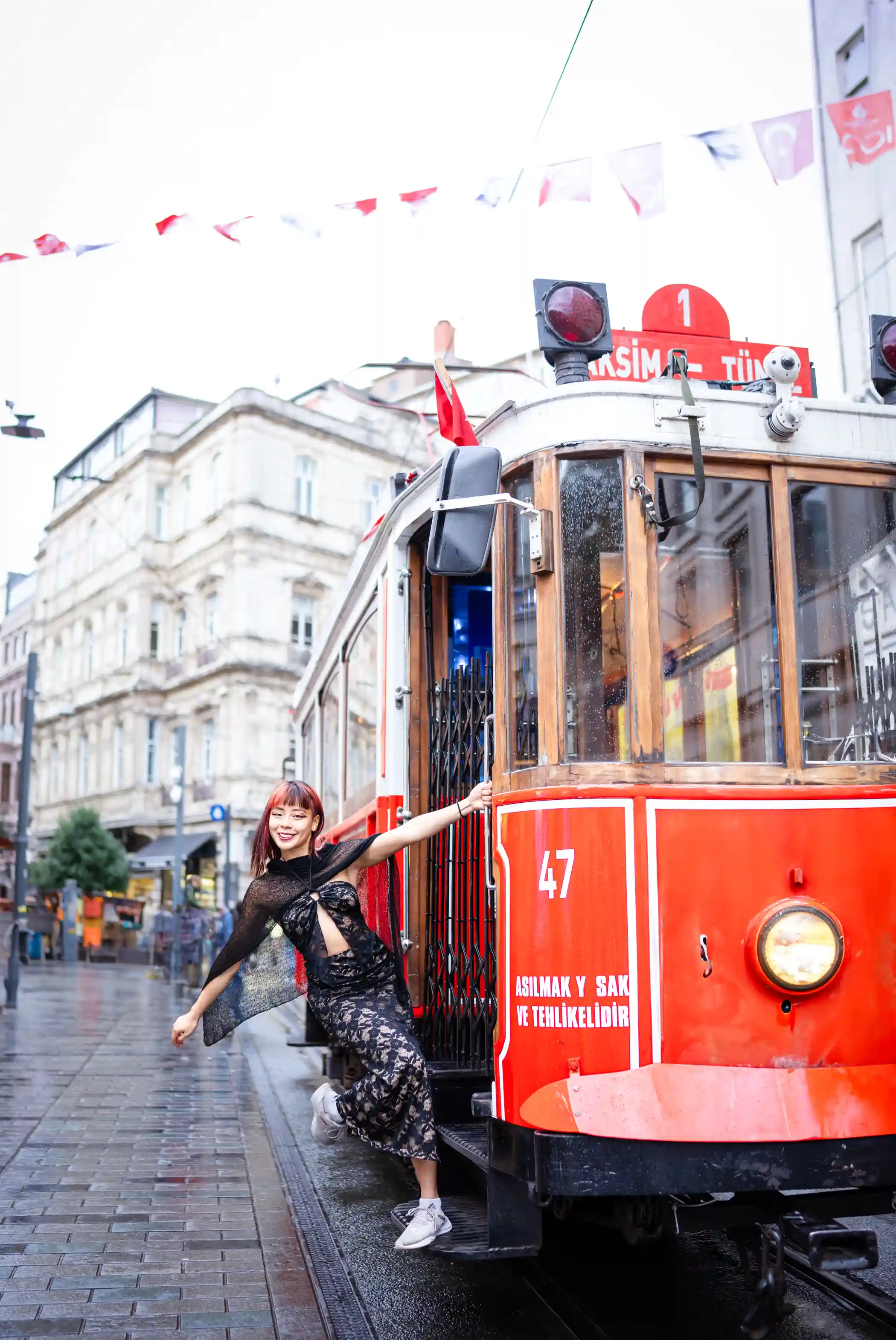 Against the lively backdrop of Istiklal Street, the Singaporean girl becomes a beacon of grace and beauty. Each photograph captures her essence, as she exudes confidence and poise amidst the vibrant energy of the bustling street. The colorful facades of the surrounding buildings provide a stunning backdrop for showcasing her allure, while the passing Red Tram adds a sense of movement and whimsy to the scene.