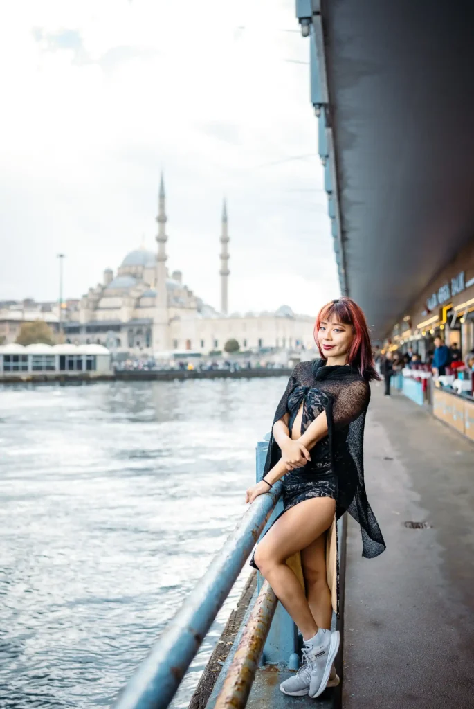 Their photo shoot becomes a celebration of cultural diversity and shared experiences. Against the backdrop of the Galata Bridge and the New Mosque, the Singaporean girl's presence serves as a reminder of the interconnectedness of global communities and the beauty that emerges when different cultures converge. In the aftermath of the photo shoot, the images serve as timeless reminders of a moment shared amidst the beauty of Istanbul's iconic landmarks. Through the lens of the camera, the Galata Bridge and the New Mosque become symbols of unity and harmony, weaving a tale of cultural exchange and mutual appreciation against the backdrop of Istanbul's enchanting cityscape.