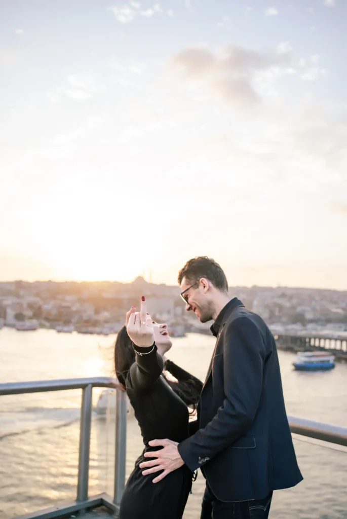 Finally, as the sun dips below the horizon and the city lights begin to twinkle like stars in the night sky, the photographer orchestrates the climactic moment—the proposal itself. Against the backdrop of one of Istanbul's most iconic settings, the couple's love takes center stage as they embrace, surrounded by the timeless beauty of the city they now share. In the end, the photographs serve as more than just mementos of a special day—they become a testament to the power of love to transcend time and space, uniting two souls in a bond that is as enduring as the city itself. As the couple celebrates their newfound commitment amidst the timeless beauty of Istanbul, they create memories that will last a lifetime, captured forever in the stunning images that tell their love story to the world.